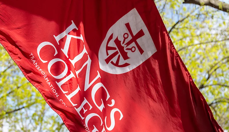 flag with king's college mission mark logo