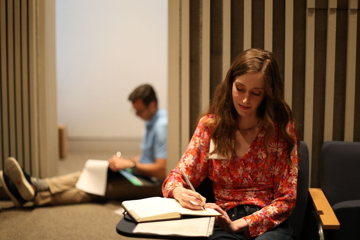 Students writing in the Burke Auditorium