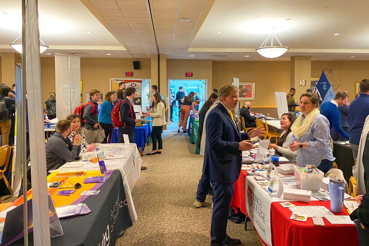 Image of tables and attendees from last year's event