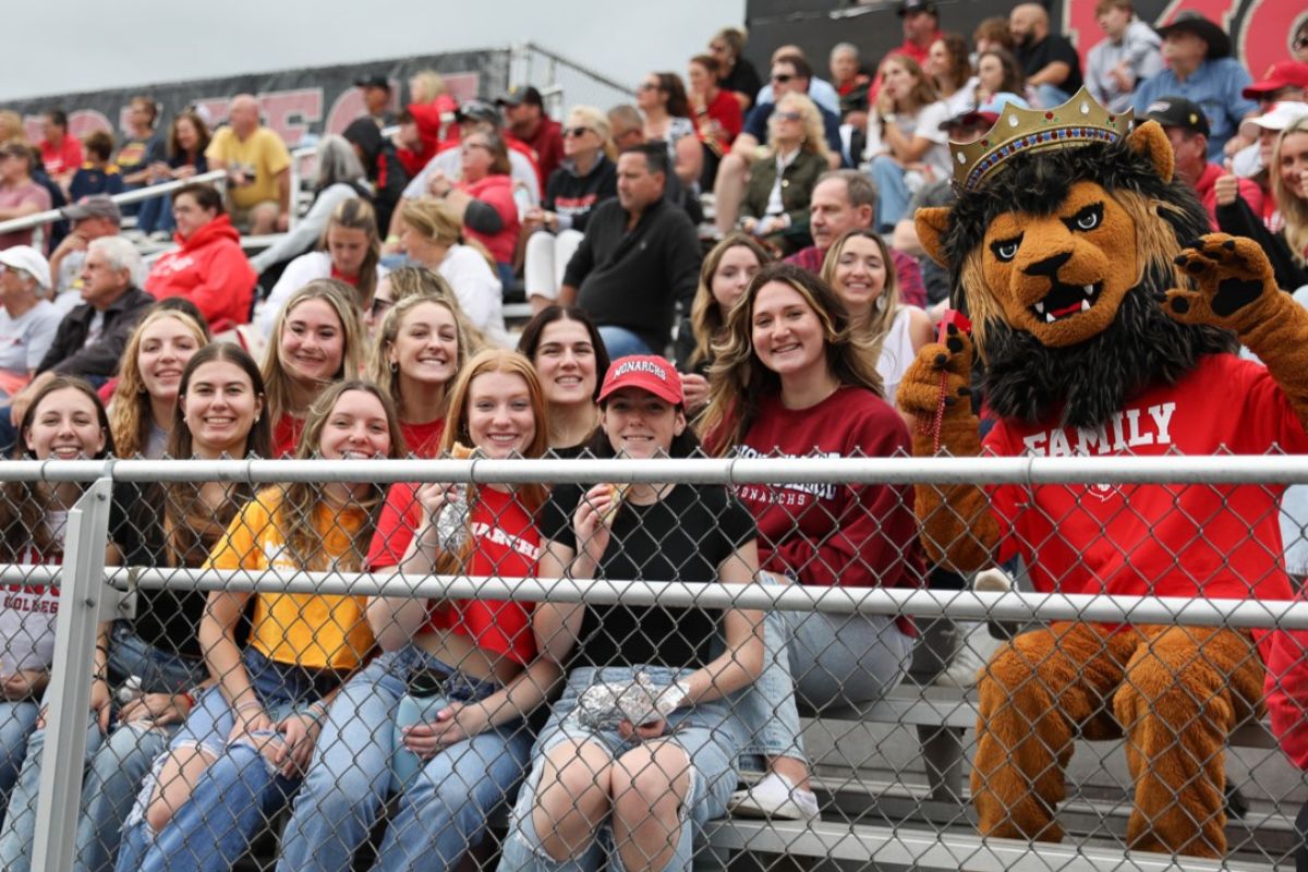 Students, family and friends with Leo at the football game