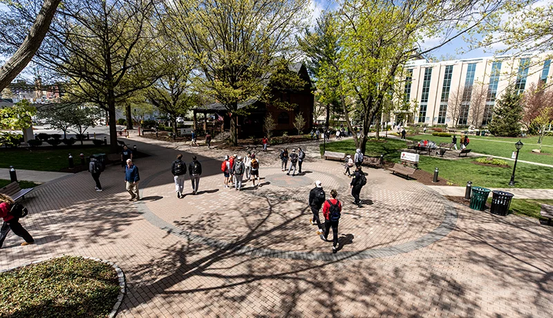 students walking through Monarch Court