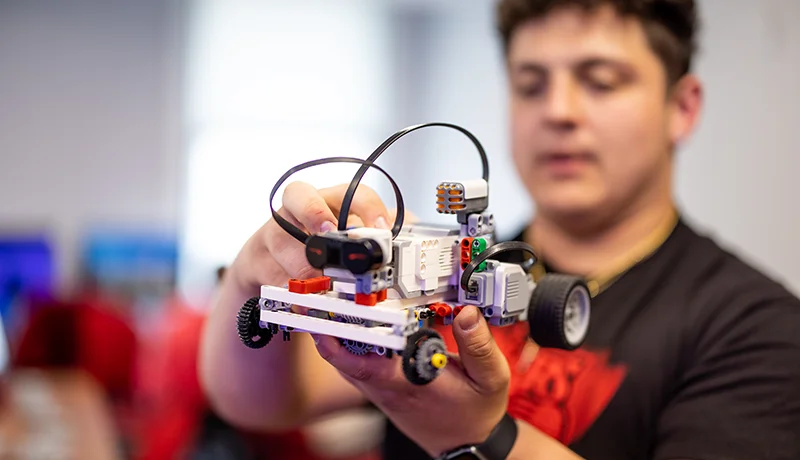 mechanical engineering degree student displaying a Lego car machine