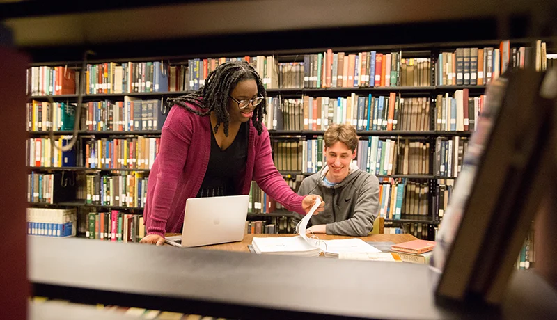 Professor and student at the library