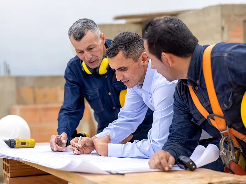 construction managers drawing on a building plan