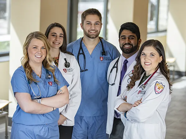 group of people in labcoats posing