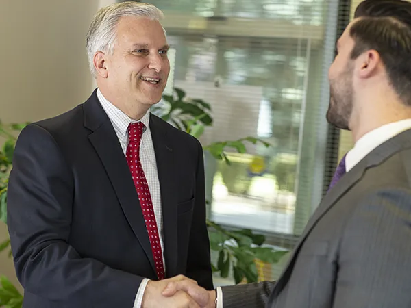 two business people in suits shaking hands