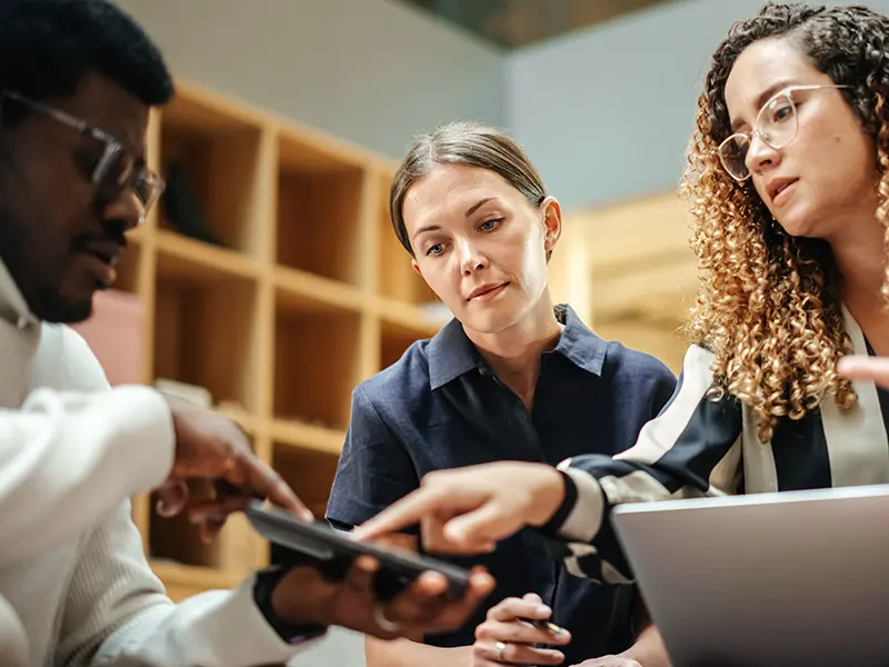 several communications specialists working together in an office