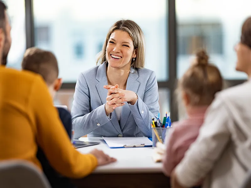 a person in a suit seated at a conference table