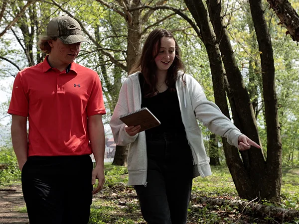 students in the woods studying the environment