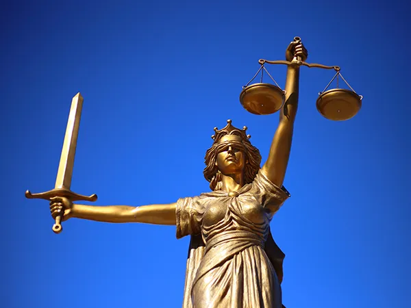 a statue holding a scale and sword