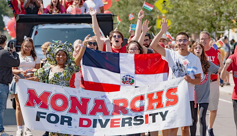 students at a diversity parade holding a banner