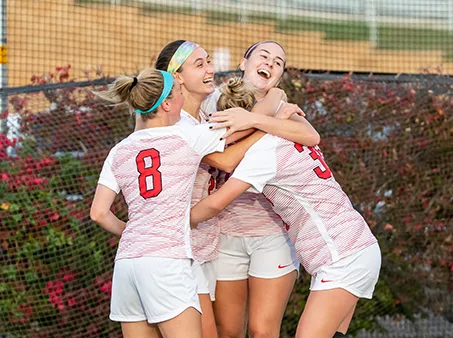 athletes hugging outdoors