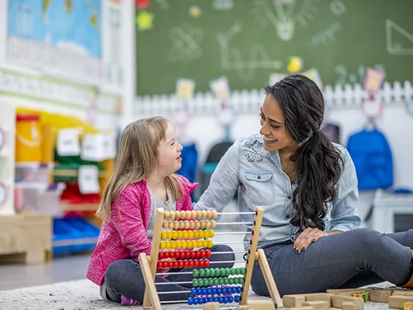 a teacher talking to a special needs students