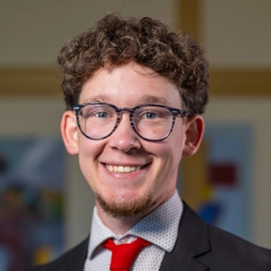 Portrait photo of Noah in a suit