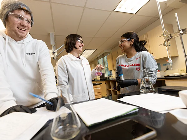 chemistry degree students and professor in science lab