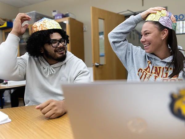 students laughing and practicing a paper brain project