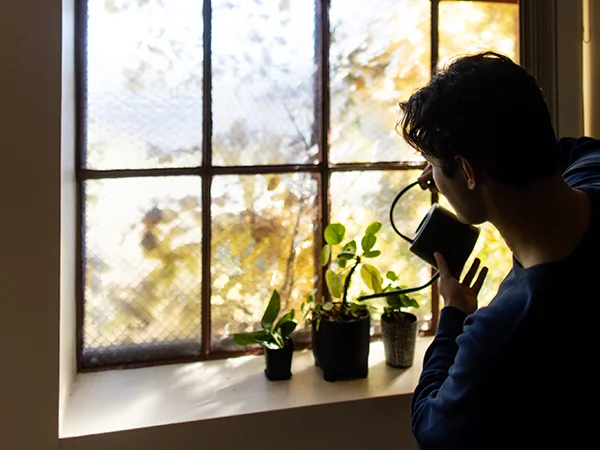 student watering plants