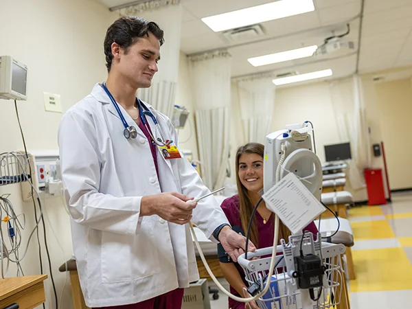 PA students using medical equipment to take vitals