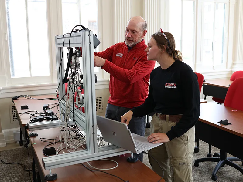 a professor and a student using a machine