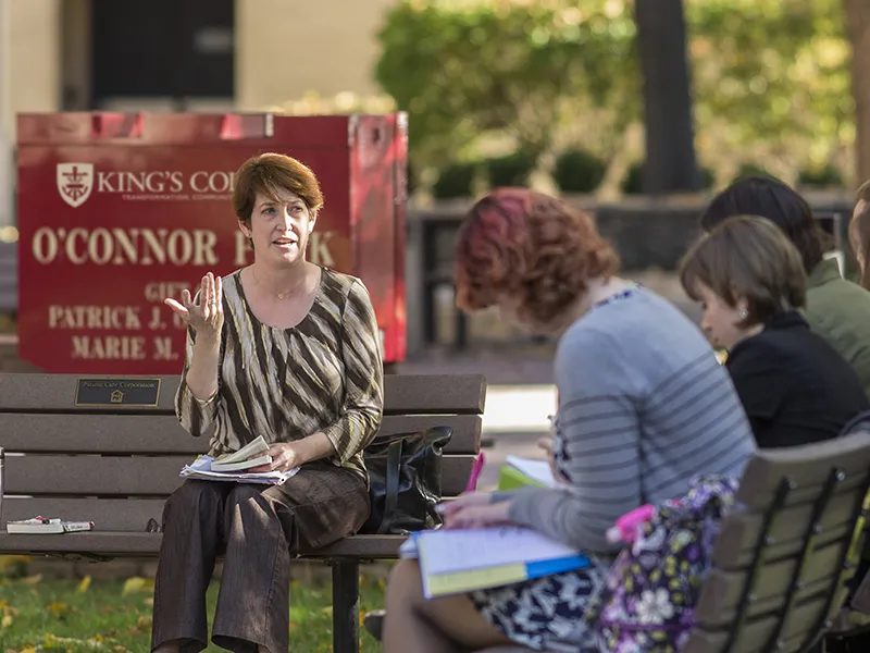 Students taking professional writing courses outdoors