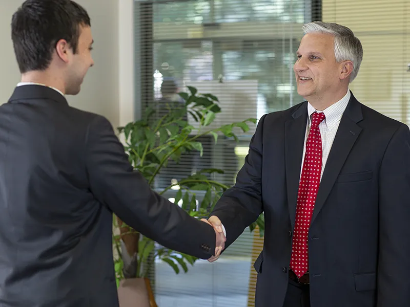 professor shaking hands with a student