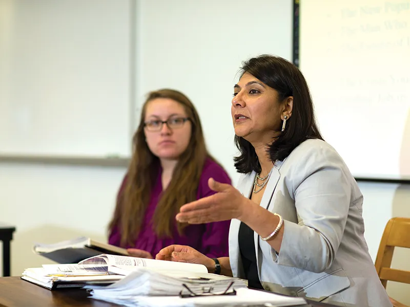 a professor lecturing in business attire