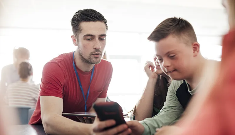 a teacher helping a special needs student