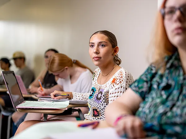 theology degree students seated at desks in theology class