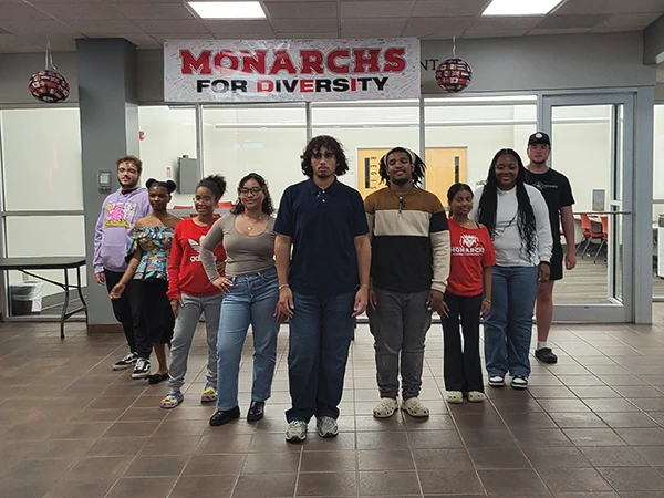students posing in the campus center