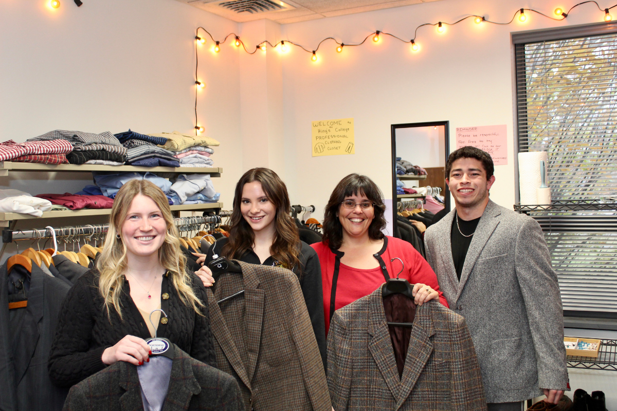 professor and students holding formal clothing
