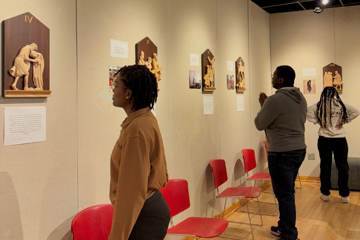 Students looking at the Social Justice Stations of the Cross.