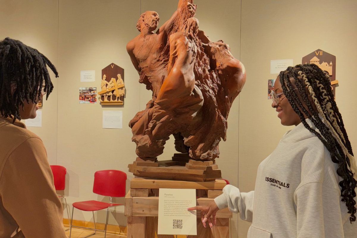 Students observing a sculpture at the gallery. 