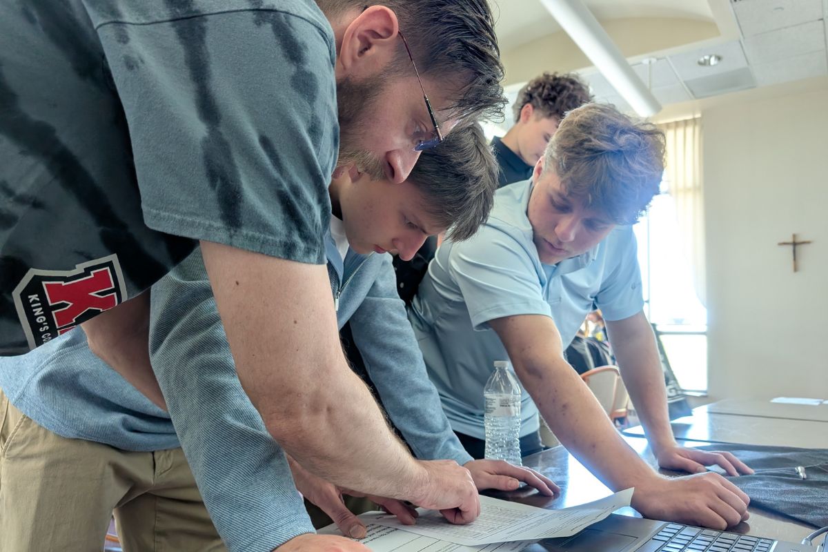 Students working with King’s College IT staff on a solution to a technology-themed escape room game.