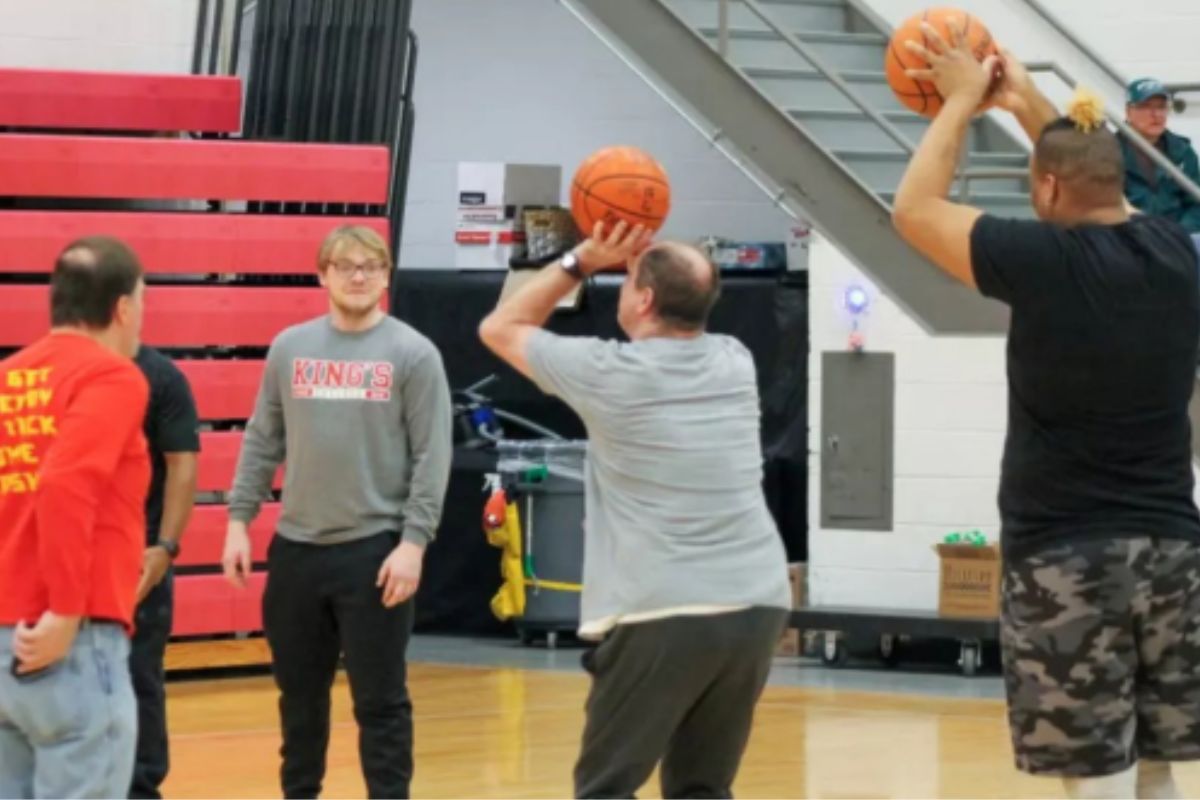 Image of the Student-Athlete Advisory Committee playing basketball with participants