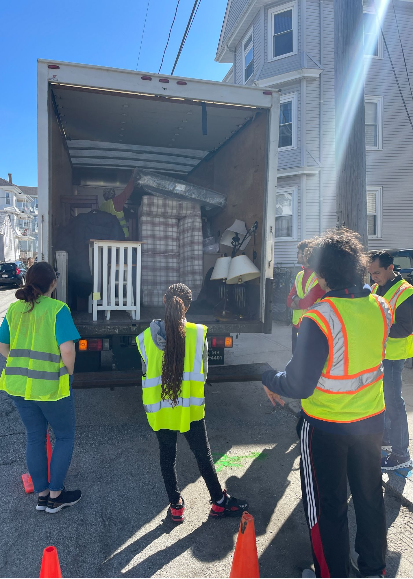 Volunteers moving furniture out of truck. 
