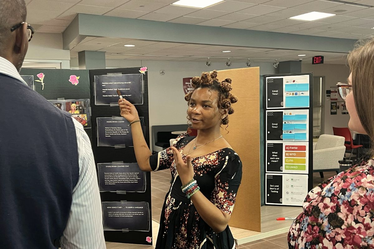 Image of student presenter teaching her native language. 