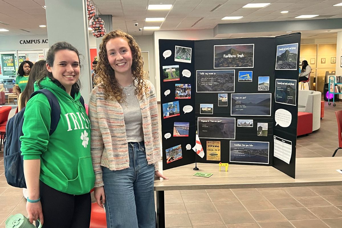 Student presenters in front of their poster board. 