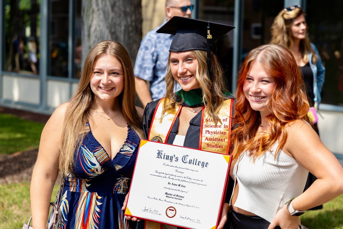 Graduates posing with family and friends
