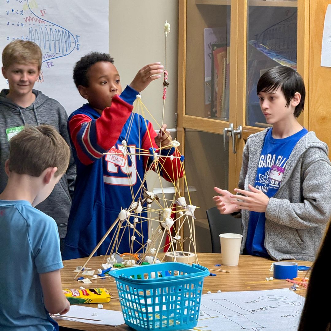 Kids building model houses using arts and crafts supplies