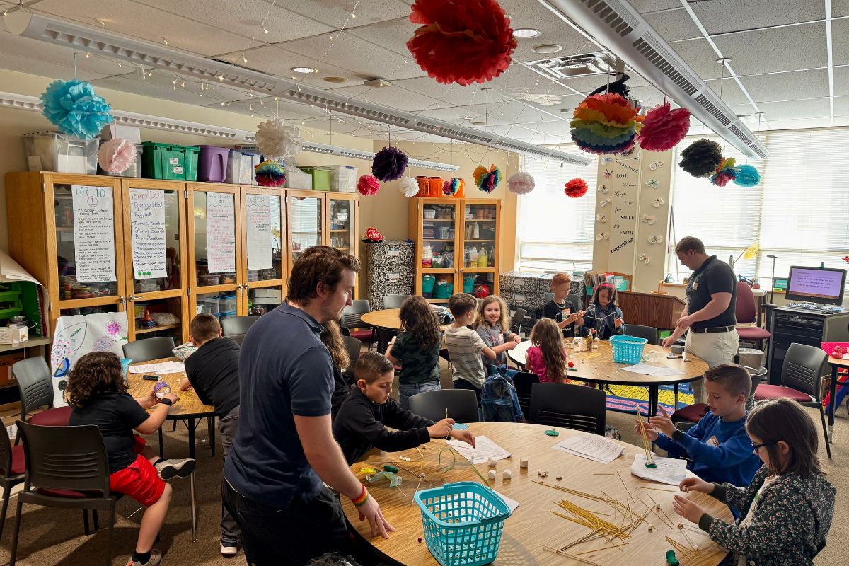Kids building model houses using arts and crafts supplies