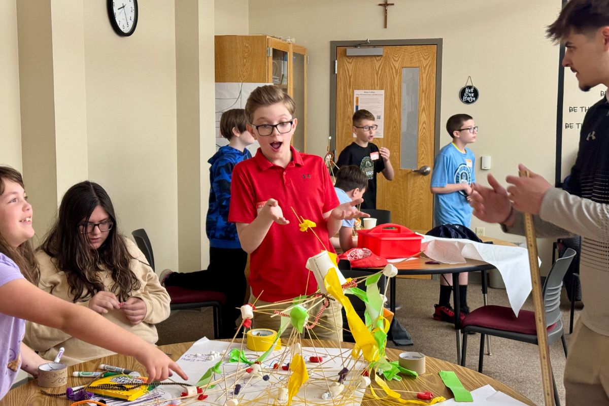 Kids building model houses using arts and crafts supplies
