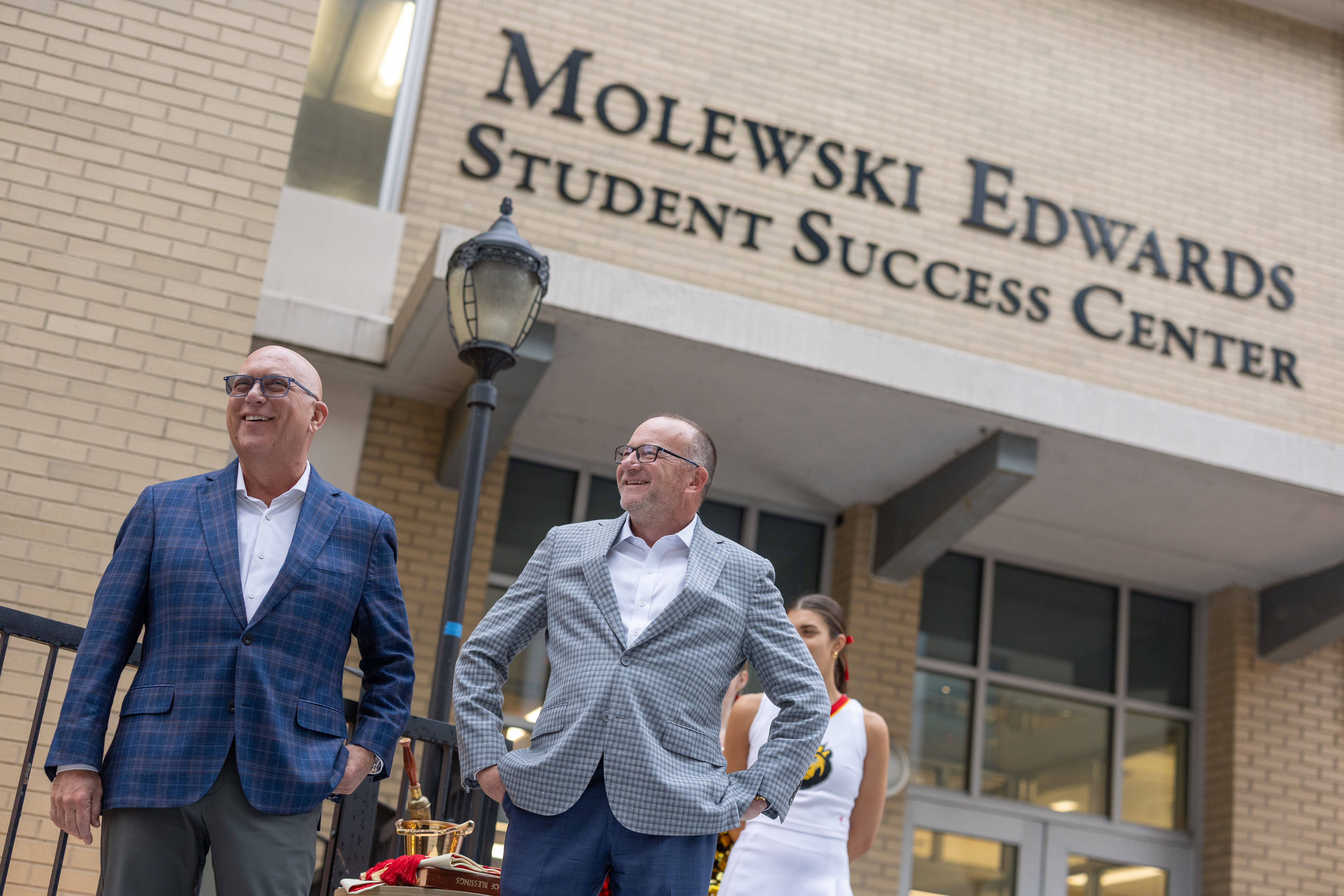 Right to Left: Mike Molewski and Jimmy Edwards standing in front of the named Student Success Center