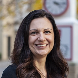 Portrait photo of Tina in professional attire.