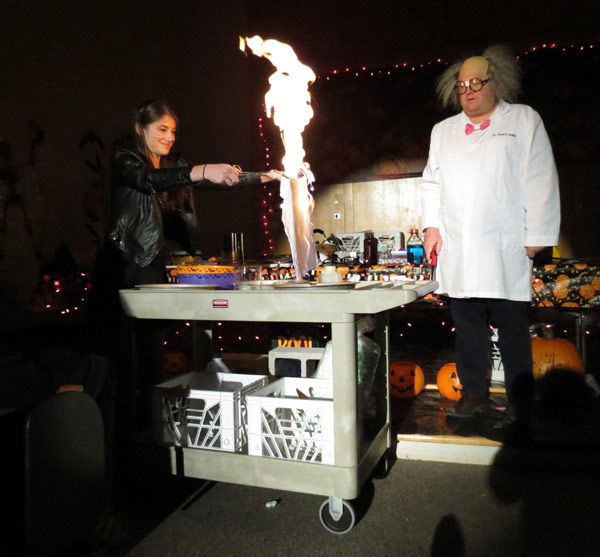 Dr. Trent Snider, associate professor of chemistry, supervises King’s student Varvara Budetti as she performs the “The Inflammable Hanky” trick as part of King’s annual children’s Halloween exhibition, "Things That Go Boom in the Night."