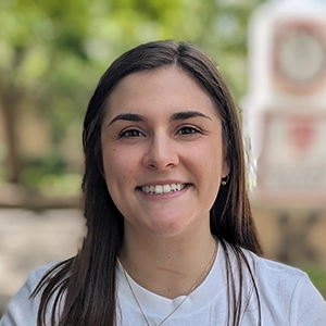 Portrait photo of Harli in professional attire.