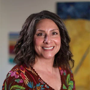 Portrait photo of Mary in professional attire.