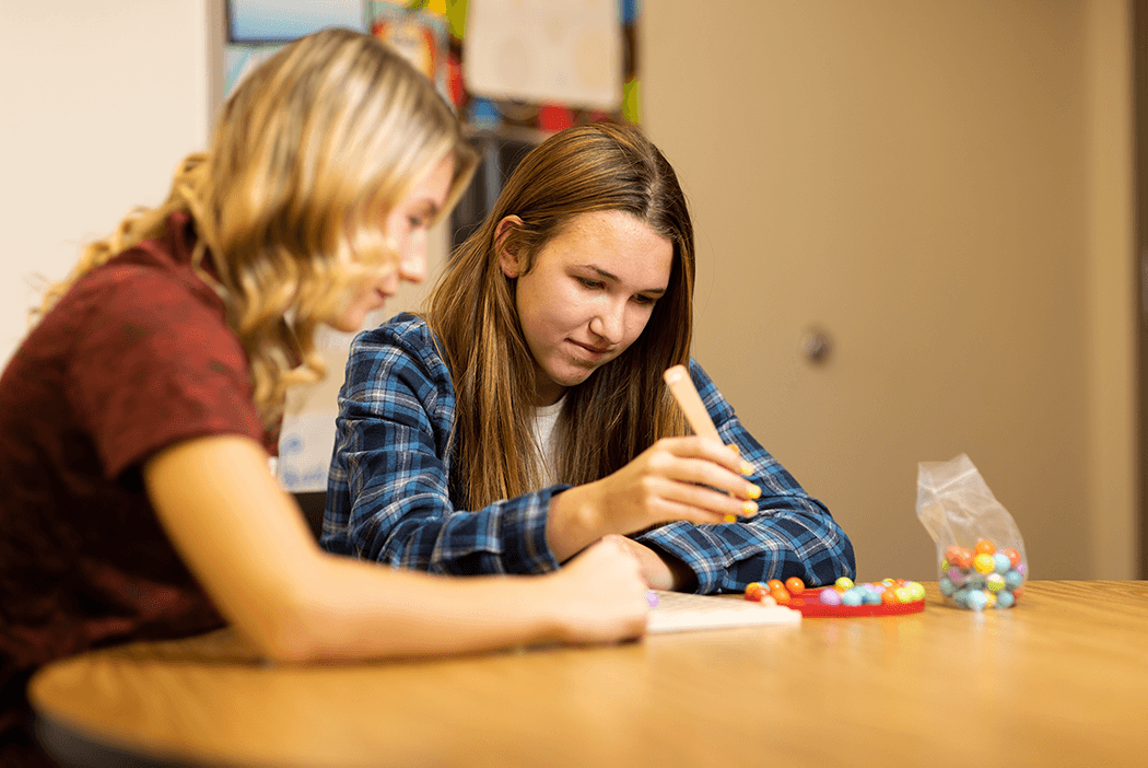 Occupational therapy students engage in an exercise with marbles.