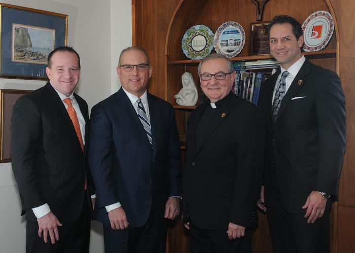 Pictured, from left, is Jim Edwards and Mike Molewski, both principals of CAPTRUST and King’s College graduates; and Father John Ryan, C.S.C., president, and Freddie Pettit, vice president for institutional advancement, King’s College.