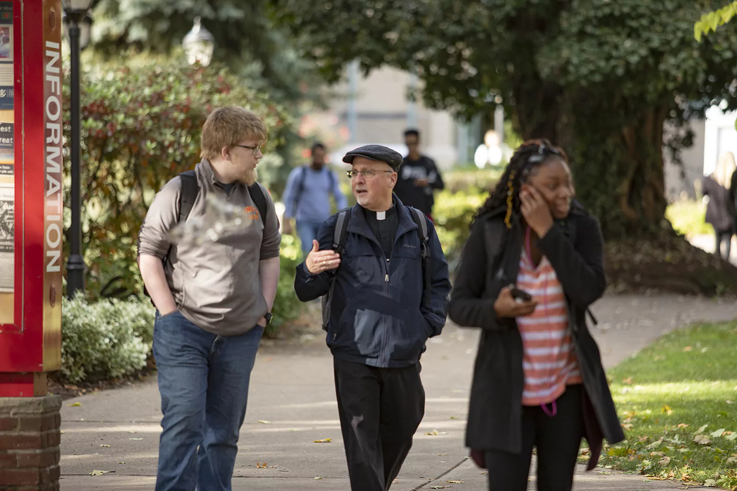Students on the campus walkways with Father Issing.
