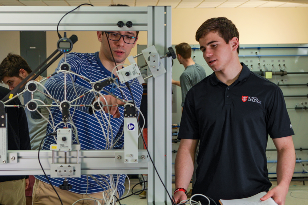 engineering students using equipment in a laboratory